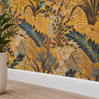 Gros plan sur le papier peint jungle jaune ocre et bleu au niveau de la plinthe