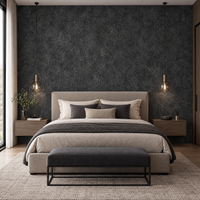 Papier peint effet béton anthracite derrière une tête de lit en chambre