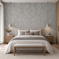 Papier peint effet béton gris clair derrière une tête de lit en chambre